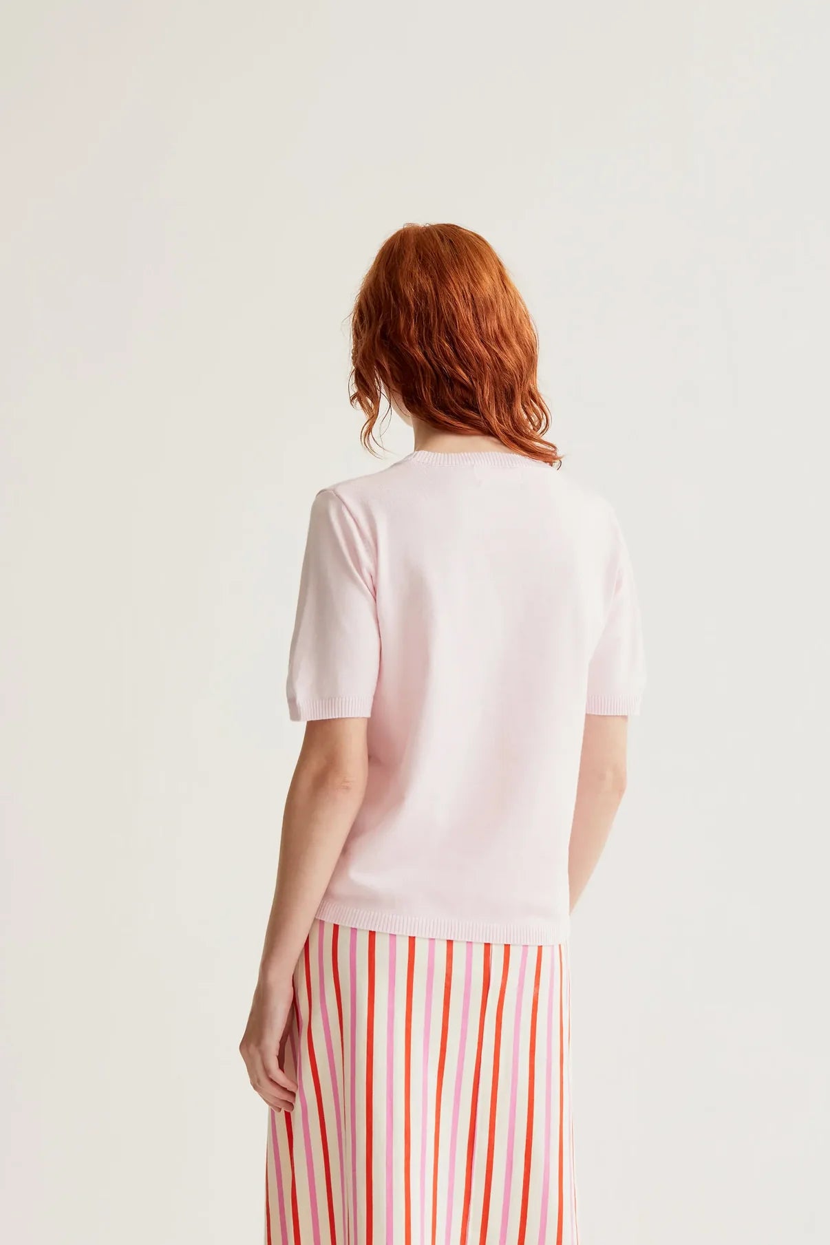 Pink knit top with watermelon embroidery